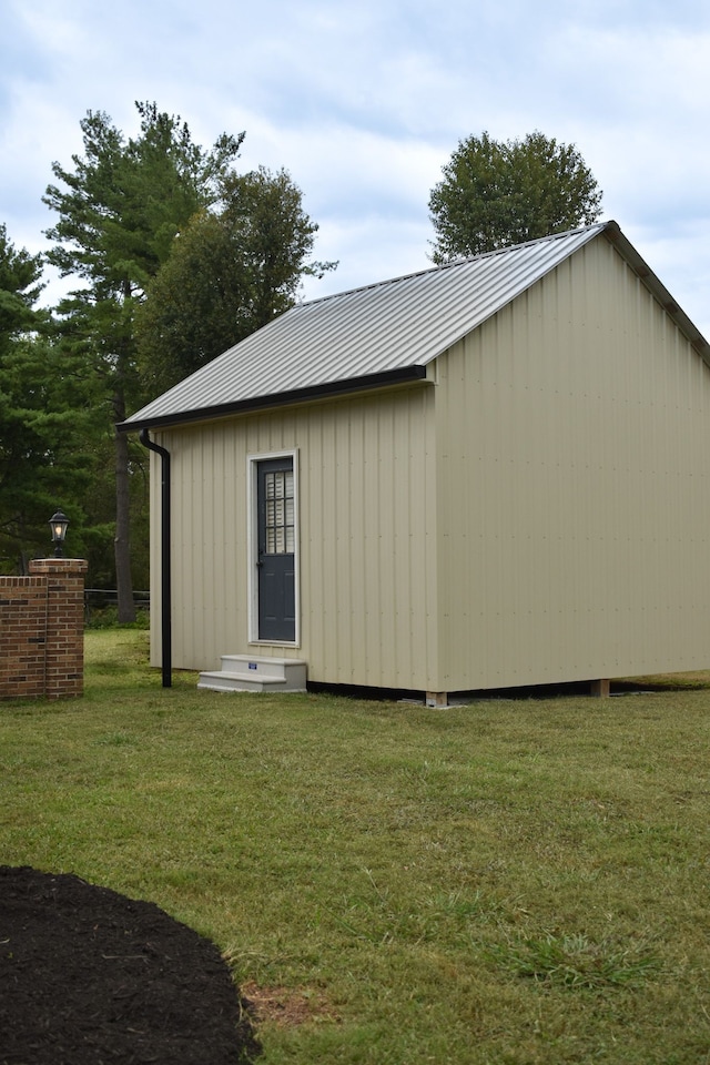 view of outdoor structure featuring a lawn