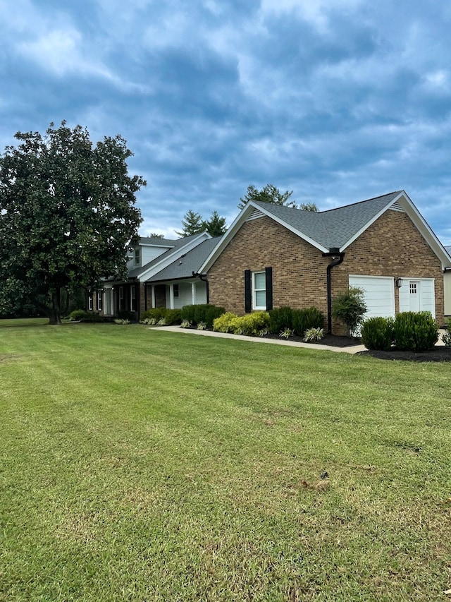 ranch-style home featuring a garage and a front yard