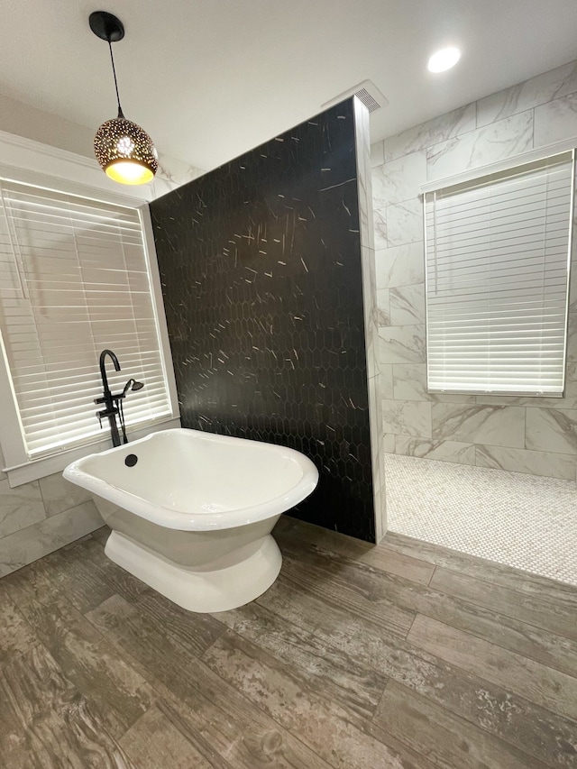 bathroom with wood-type flooring and separate shower and tub