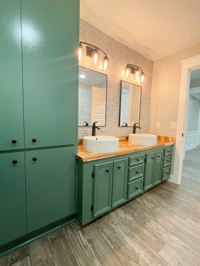 bathroom featuring backsplash, hardwood / wood-style flooring, and vanity