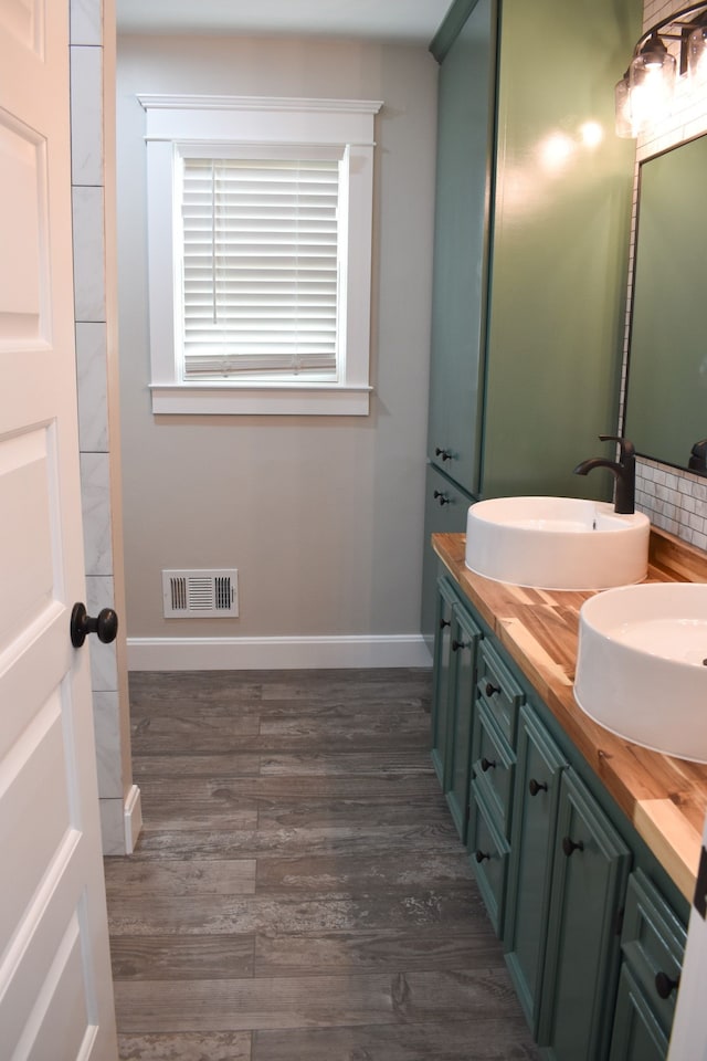 bathroom featuring vanity and wood-type flooring