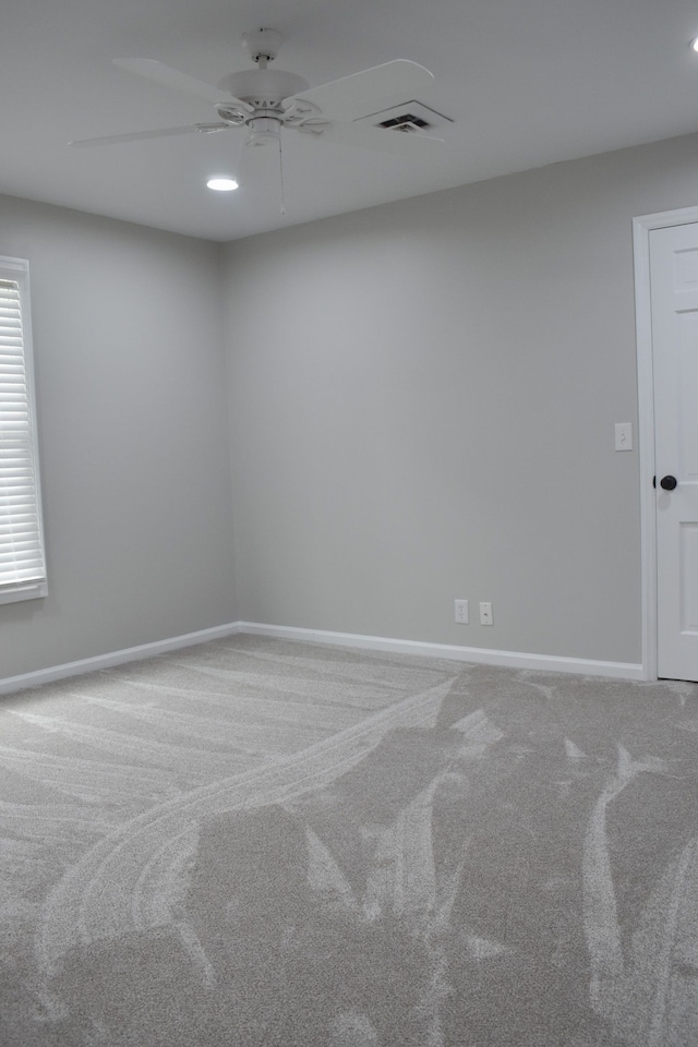 carpeted empty room with ceiling fan