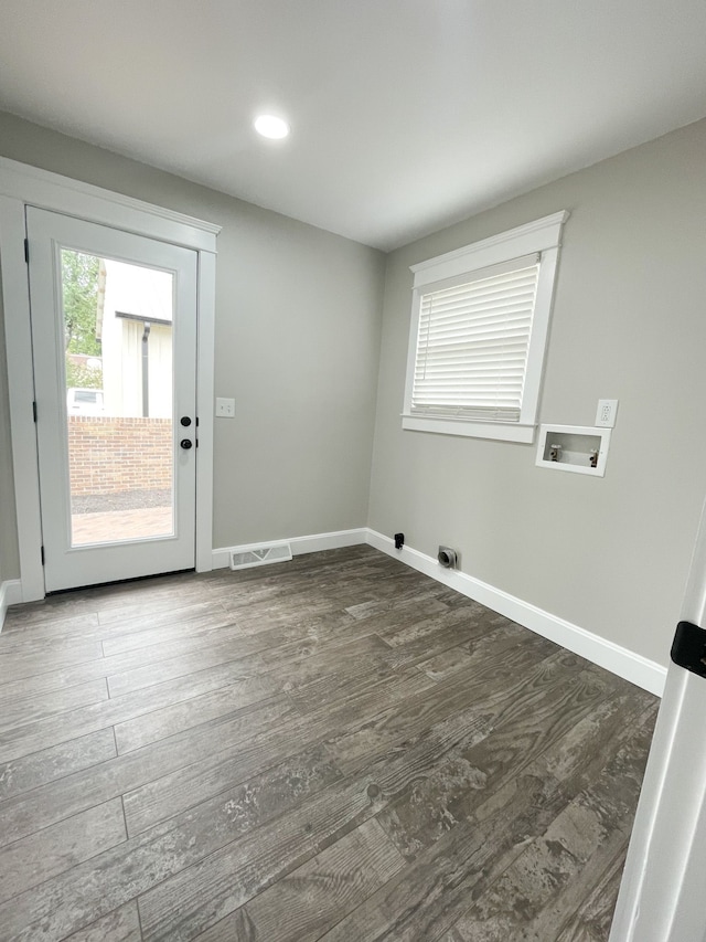 clothes washing area featuring dark wood-type flooring and washer hookup