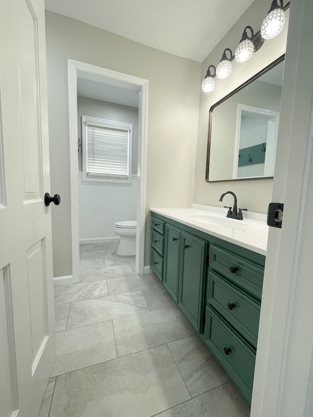 bathroom featuring toilet and vanity