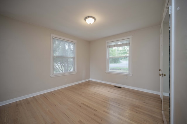 empty room with light hardwood / wood-style flooring