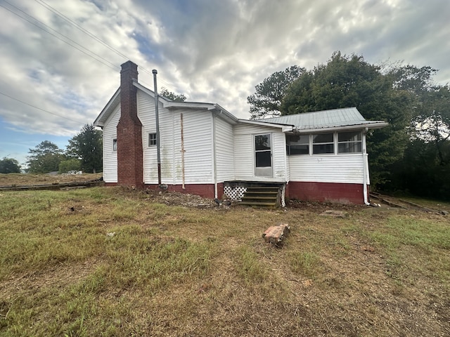 back of property with a lawn