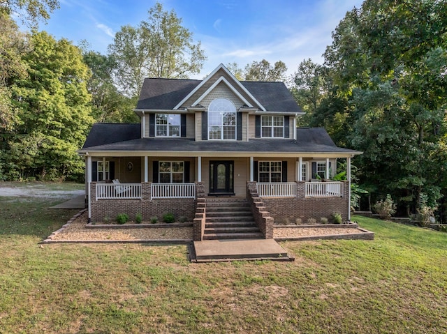 view of front of home with a front yard and covered porch