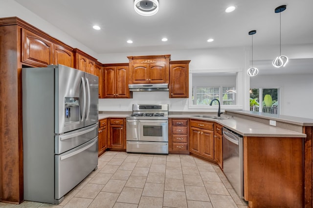 kitchen with pendant lighting, sink, light tile patterned floors, appliances with stainless steel finishes, and kitchen peninsula