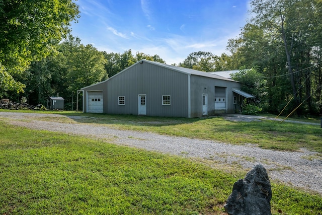 view of home's exterior featuring an outbuilding and a lawn