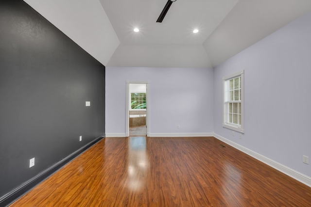 spare room featuring vaulted ceiling, hardwood / wood-style floors, and ceiling fan