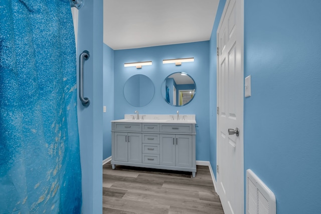 bathroom with vanity and hardwood / wood-style floors