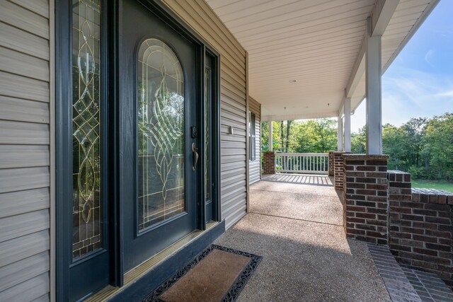 view of exterior entry with covered porch