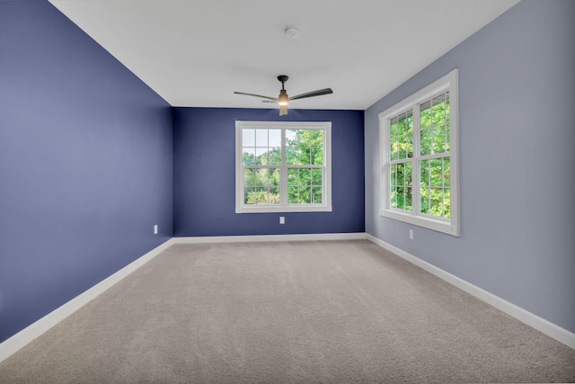 unfurnished room featuring carpet and ceiling fan