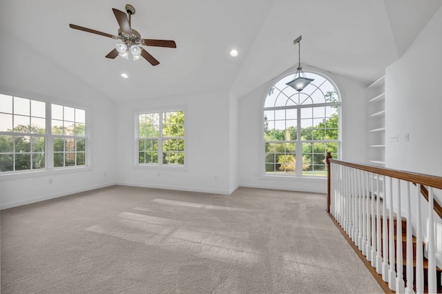 unfurnished sunroom featuring ceiling fan, lofted ceiling, and plenty of natural light