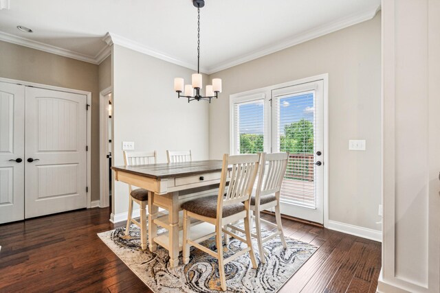 dining area featuring ornamental molding, dark wood-type flooring, and an inviting chandelier