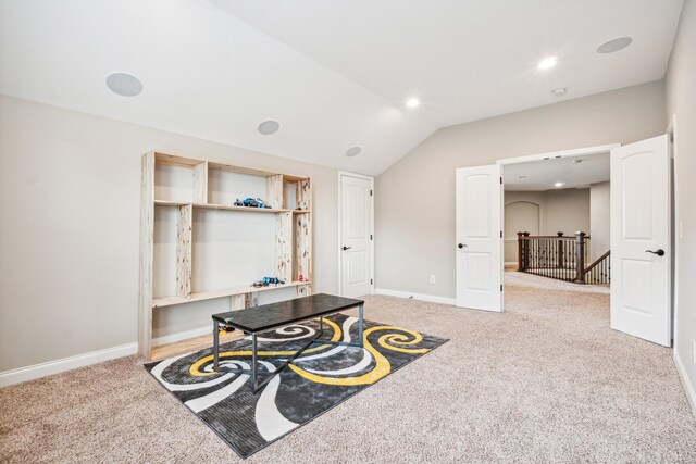 interior space with carpet and vaulted ceiling