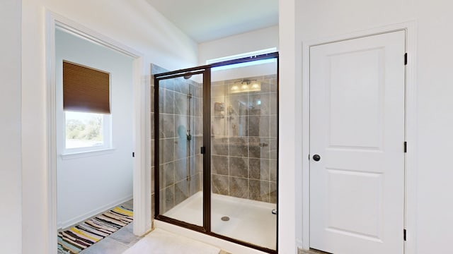 bathroom featuring a shower with shower door