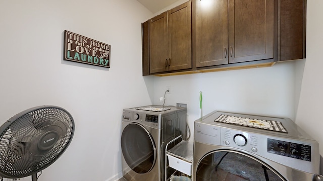 laundry area with washer and clothes dryer and cabinets