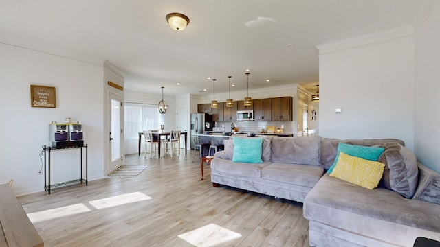 living room with light hardwood / wood-style floors and ornamental molding