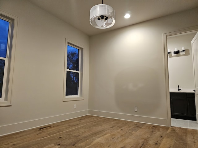 unfurnished room featuring sink and light wood-type flooring