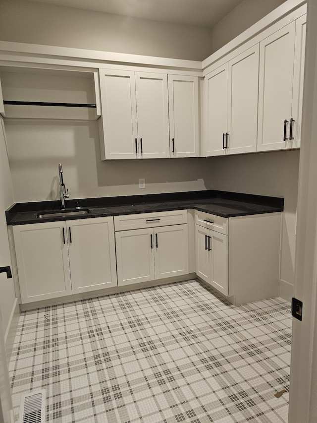 kitchen featuring sink and white cabinets