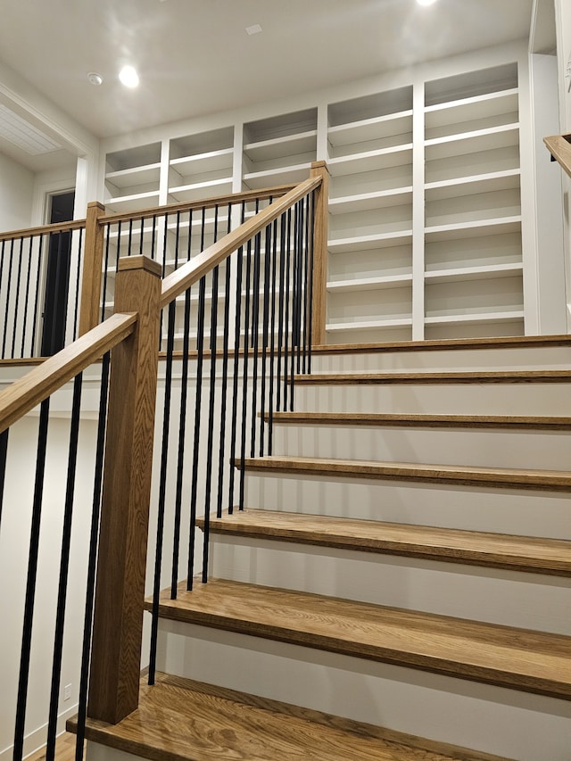 stairway with hardwood / wood-style floors