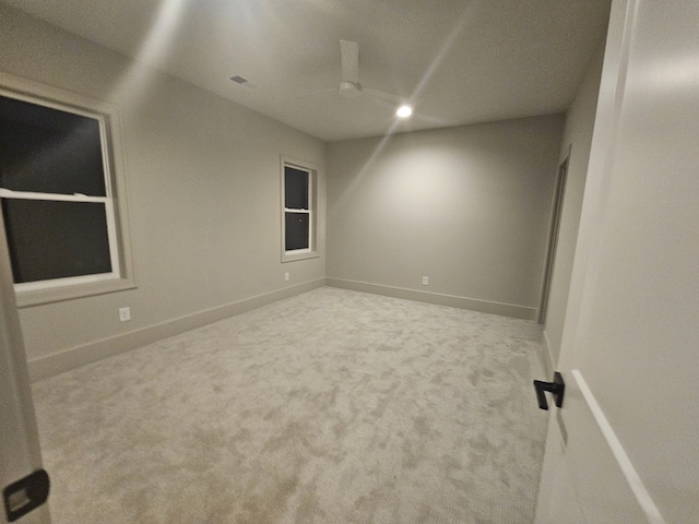 unfurnished room featuring light carpet