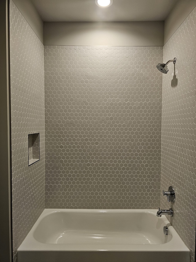 bathroom featuring tiled shower / bath