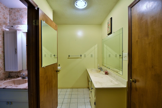 bathroom with vanity, a textured ceiling, and tile patterned flooring