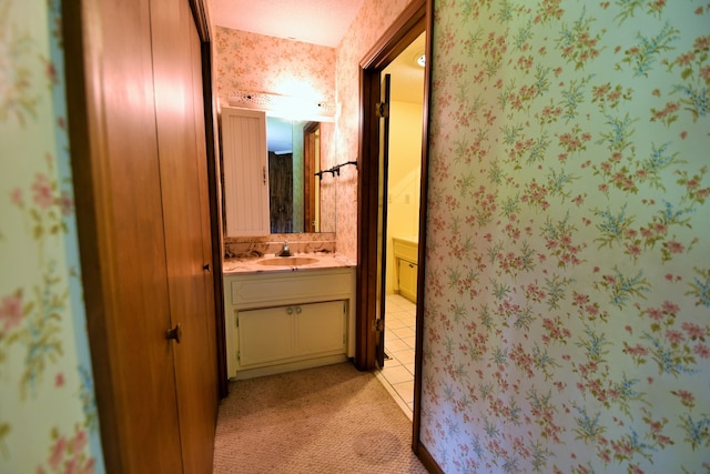 hall with light colored carpet and sink