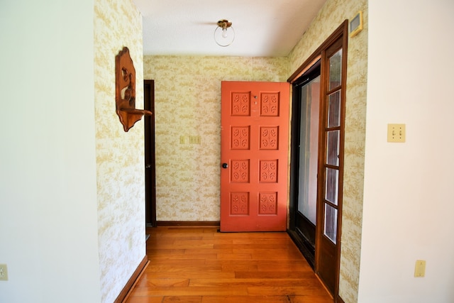 corridor with hardwood / wood-style flooring