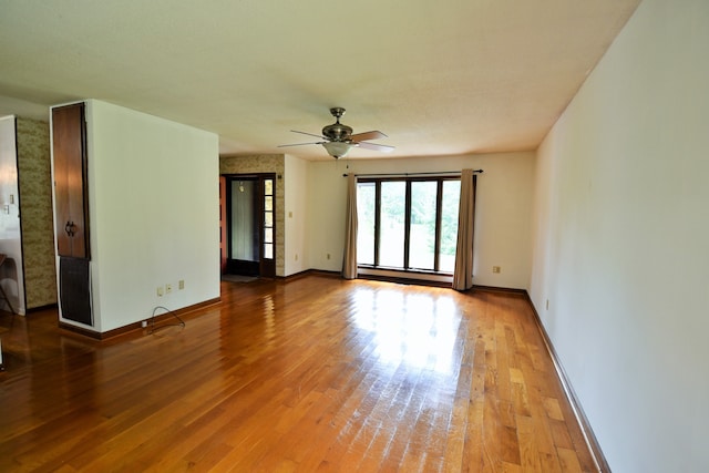 empty room featuring wood-type flooring and ceiling fan