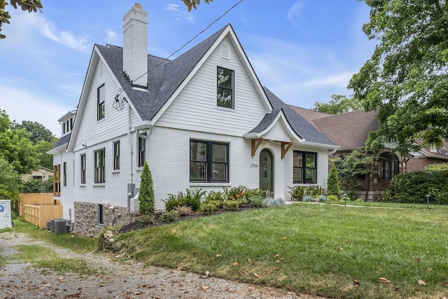 2704 Westwood Ave, Nashville, TN 37212 - view of front of home featuring a chimney, a front lawn, brick siding, fence, and a shingled roof