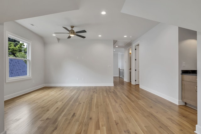 unfurnished living room featuring light hardwood / wood-style flooring and ceiling fan