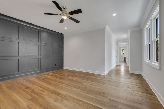 unfurnished room with light wood-type flooring, ceiling fan, and ornamental molding