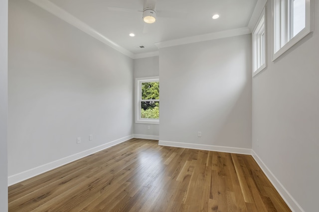 spare room with crown molding, light hardwood / wood-style flooring, and ceiling fan