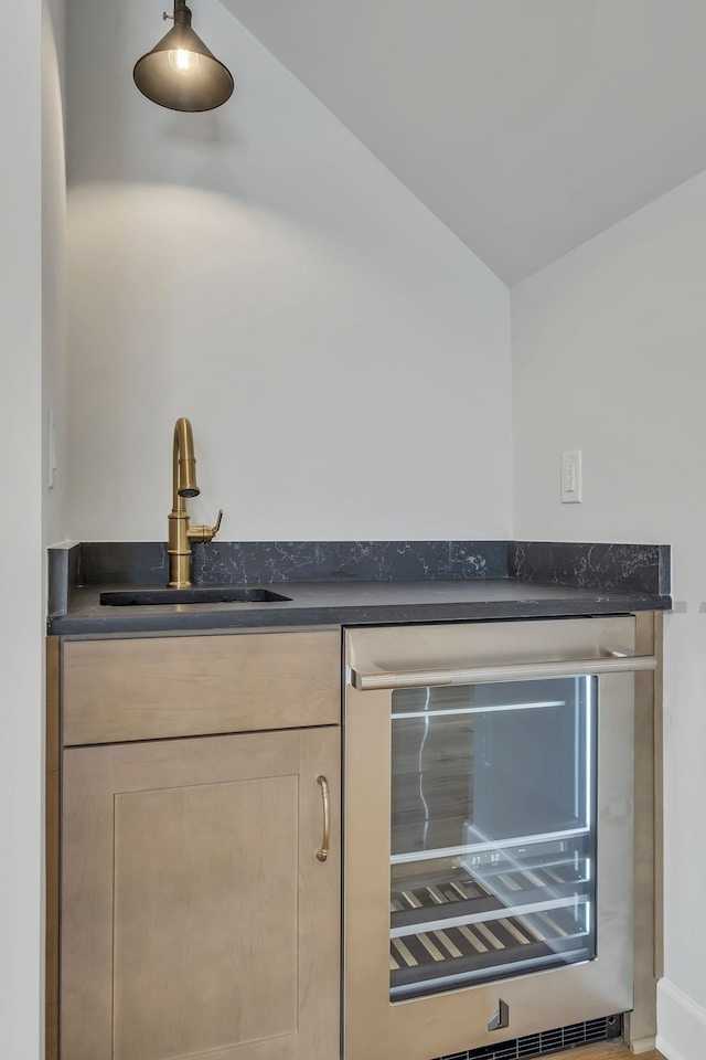 bar with lofted ceiling, wine cooler, sink, and light brown cabinets