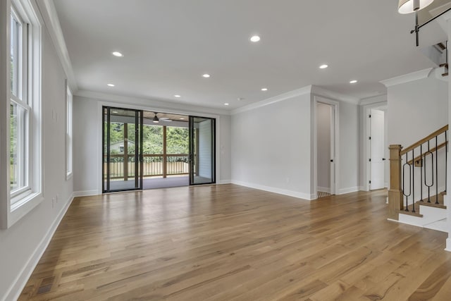 2704 Westwood Ave, Nashville, TN 37212 - unfurnished living room with crown molding, recessed lighting, light wood-style floors, and stairs
