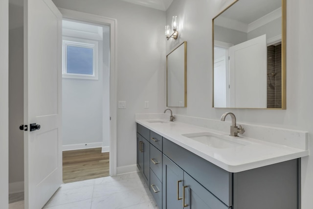 2704 Westwood Ave, Nashville, TN 37212 - full bathroom featuring double vanity, marble finish floor, a sink, and baseboards