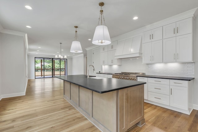 2704 Westwood Ave, Nashville, TN 37212 - kitchen featuring an island with sink, custom exhaust hood, a sink, dark countertops, and decorative backsplash