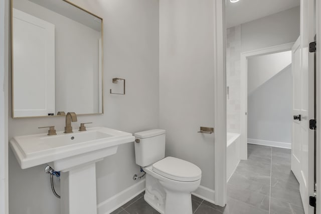 bathroom with toilet and a washtub