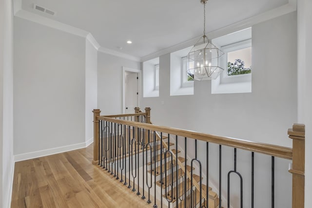 2704 Westwood Ave, Nashville, TN 37212 - corridor featuring baseboards, ornamental molding, an upstairs landing, visible vents, and wood finished floors