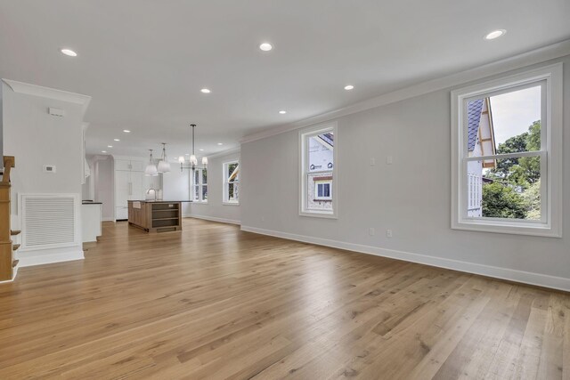 2704 Westwood Ave, Nashville, TN 37212 - unfurnished living room with an inviting chandelier, recessed lighting, crown molding, visible vents, and light wood finished floors