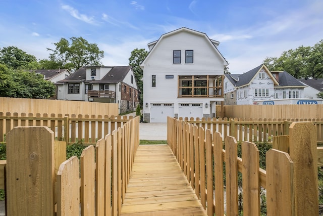 rear view of property featuring a garage