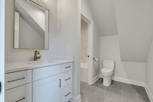 bathroom featuring lofted ceiling, toilet, and vanity