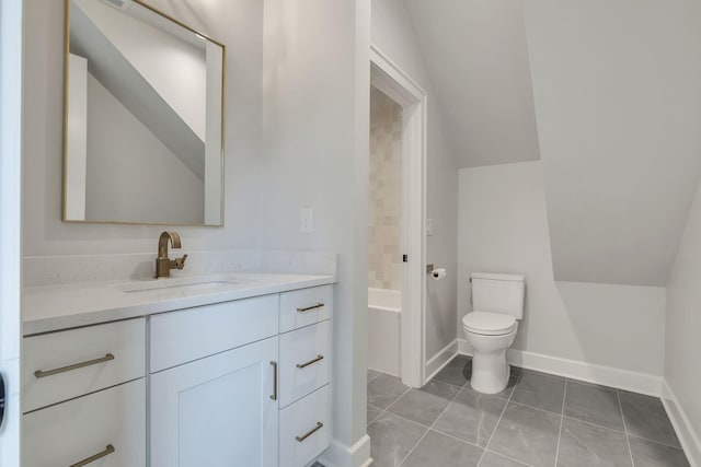 2704 Westwood Ave, Nashville, TN 37212 - full bathroom with vanity, tile patterned flooring, vaulted ceiling, toilet, and baseboards