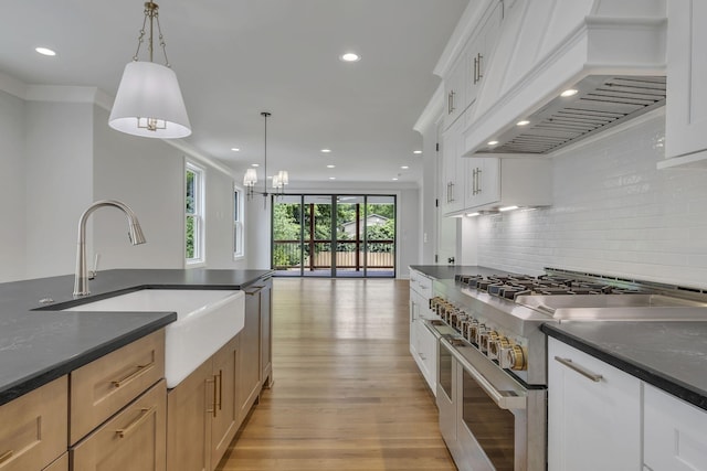 2704 Westwood Ave, Nashville, TN 37212 - kitchen featuring a sink, dark countertops, light wood-style floors, double oven range, and custom range hood