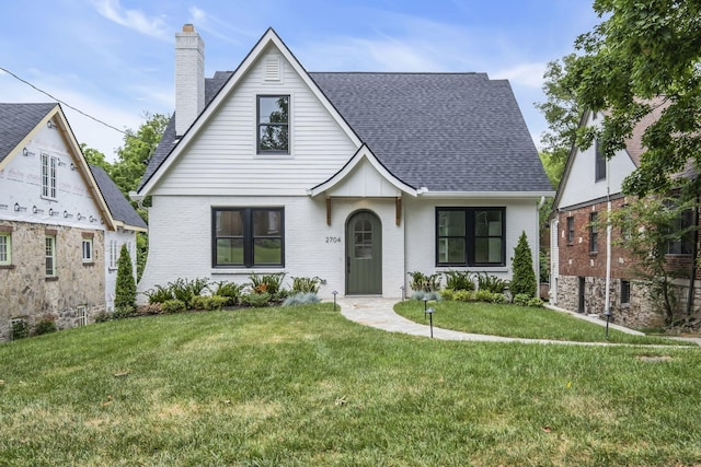 2704 Westwood Ave, Nashville, TN 37212 - view of front of house featuring roof with shingles, a chimney, a front yard, and brick siding