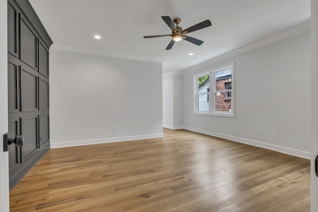 spare room with light wood-type flooring, ceiling fan, and crown molding