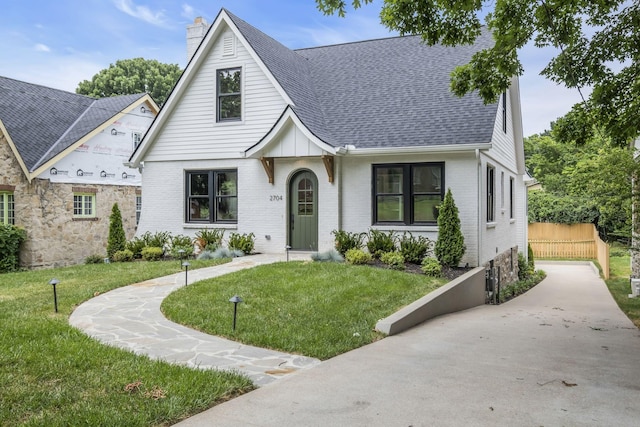 2704 Westwood Ave, Nashville, TN 37212 - view of front of house featuring a shingled roof, brick siding, a chimney, and a front lawn